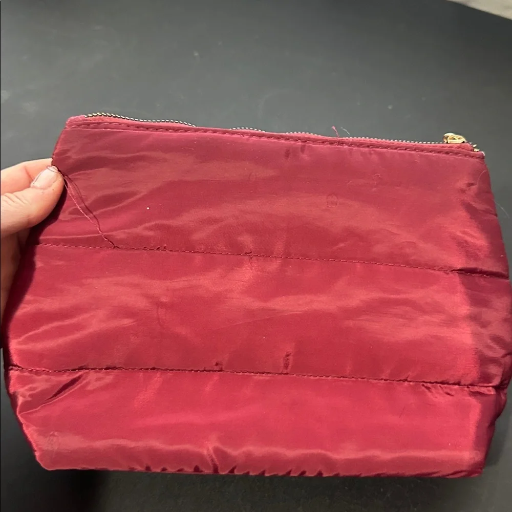 Laura Geller maroon cosmetic bag